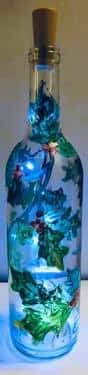 Holiday holly clear wine bottle with fairy lights