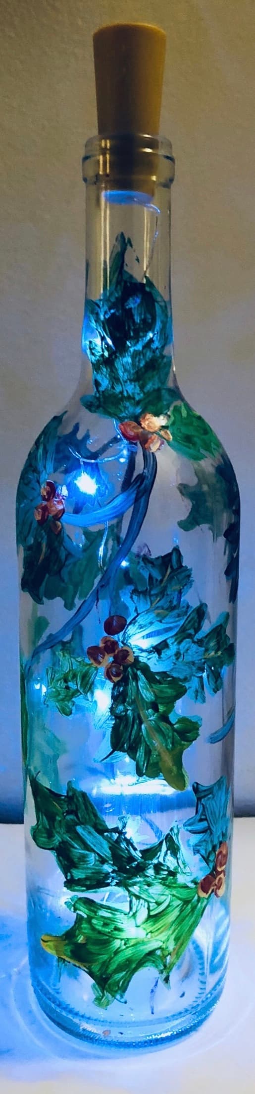 Holiday holly clear wine bottle with fairy lights